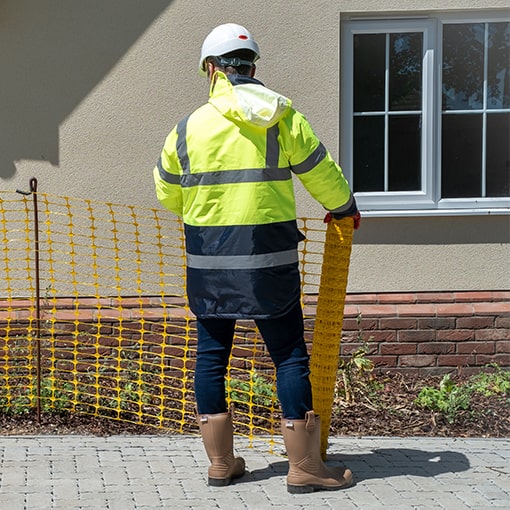 Workman with Barrier Fencing